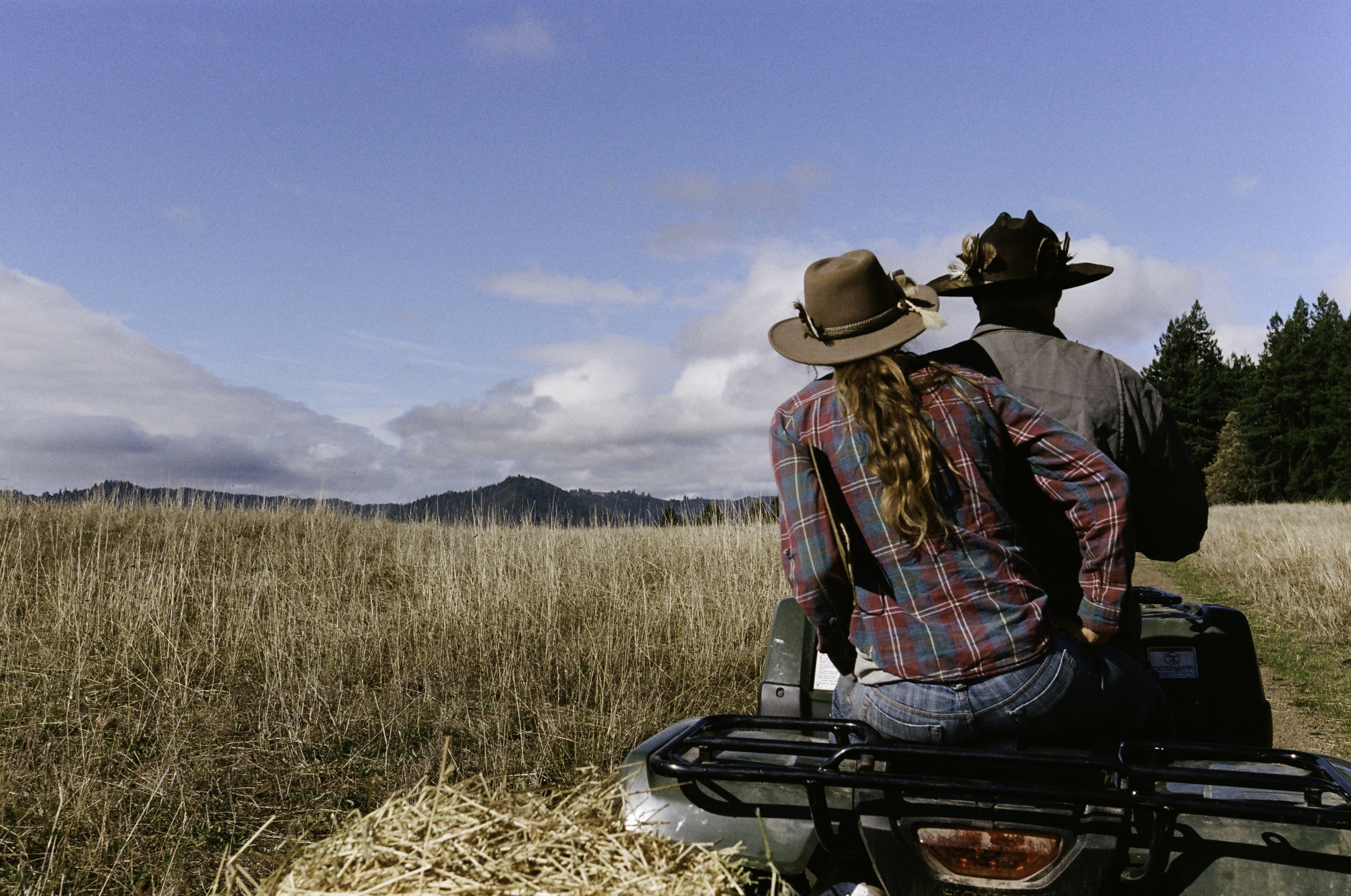  Erik Markegard and ranchhand Suzanna "Suey" Hall ride over to feed the herd. - Jenner, CA 