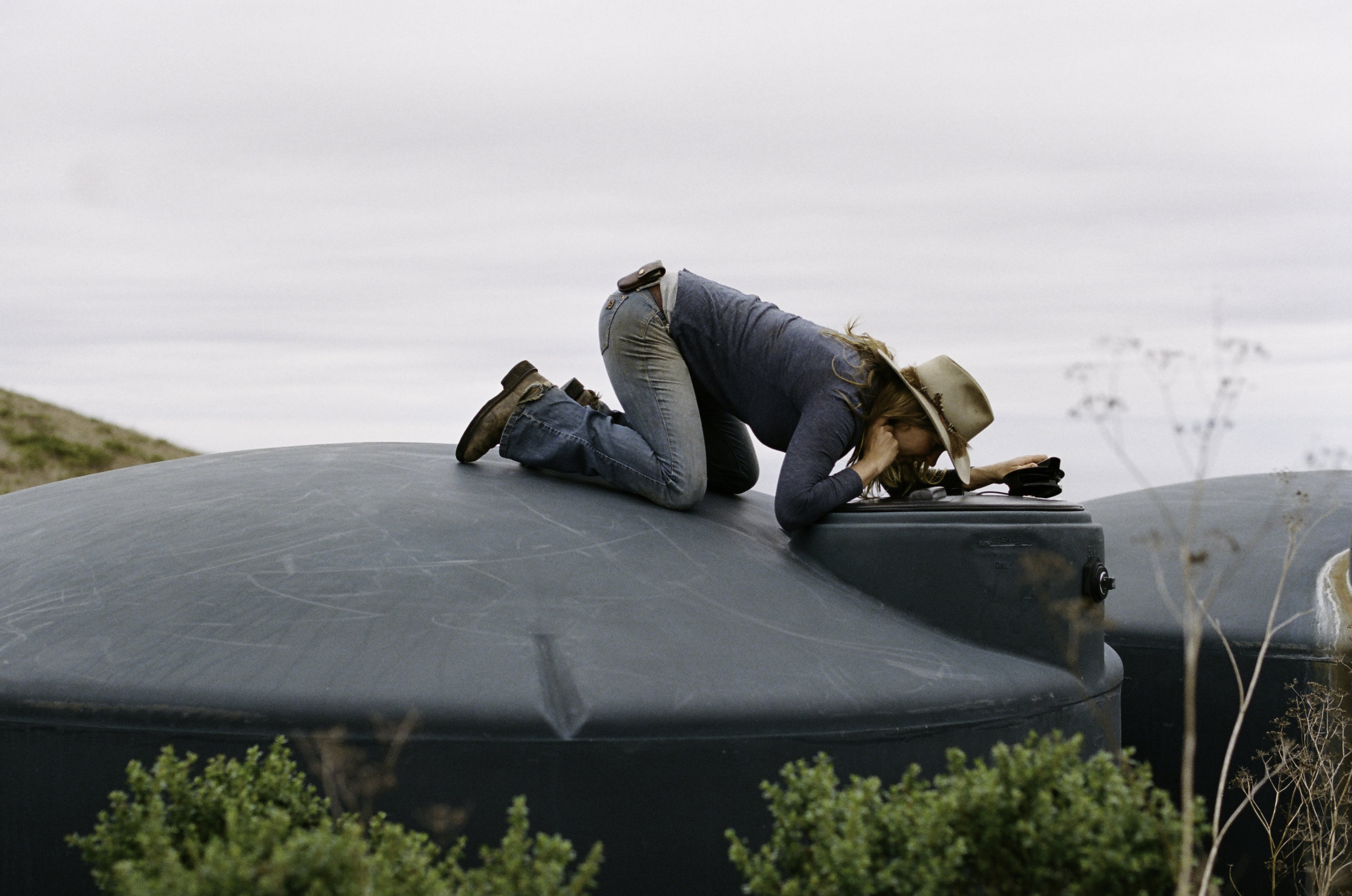  Doniga checking the water levels from their windmill-powered well. It's lower than expected. - Half Moon Bay, CA 