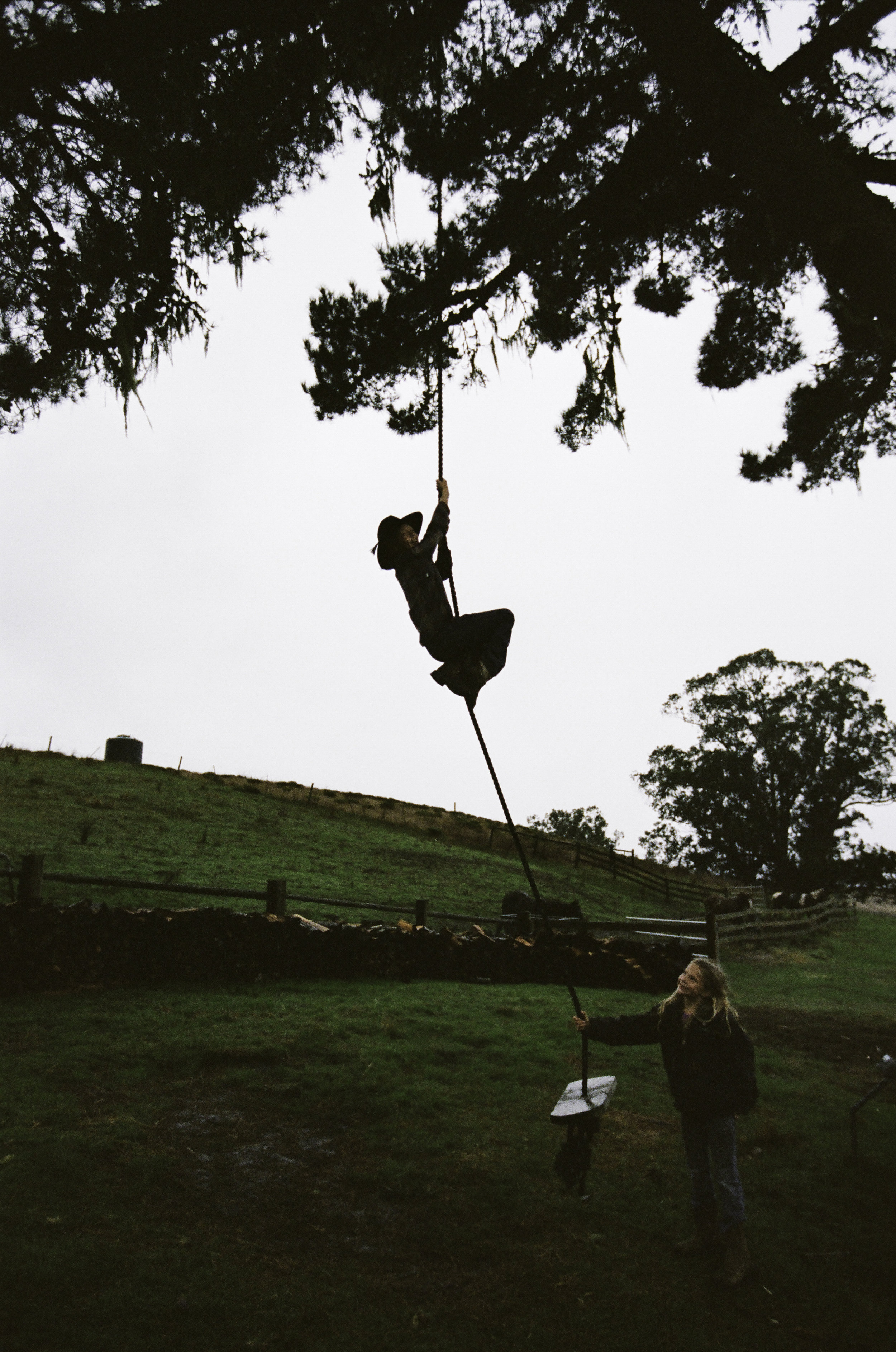  Larry, one of four kids, climbs the swing while his sister, Quill, watches. -&nbsp;San Gregorio, CA 