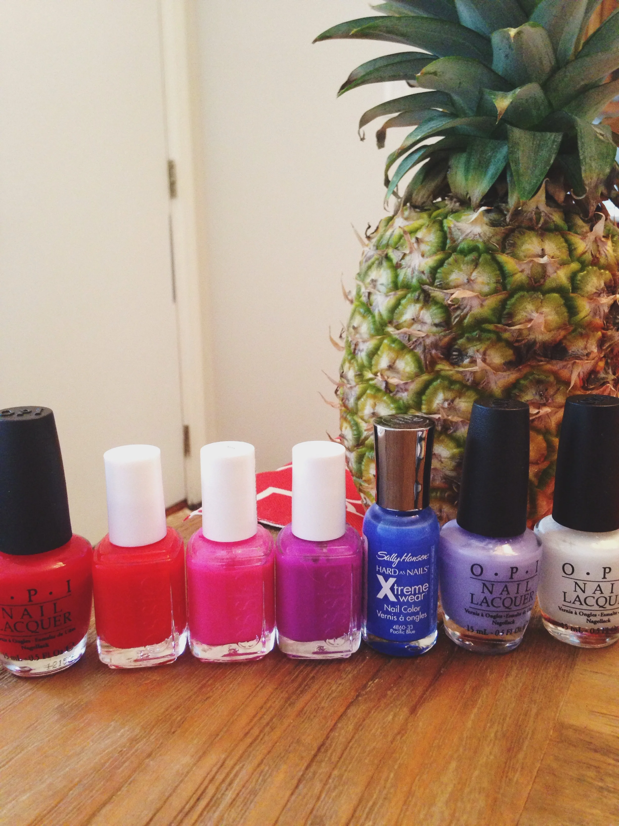L to R: OPI "Big Apple Red", Essie "Geranium", Essie "Lights", Essie "DJ Play That Song", Sally Hansen "Pacific Blue", OPI "You're Such a Budapest", OPI "Alpine Snow" 