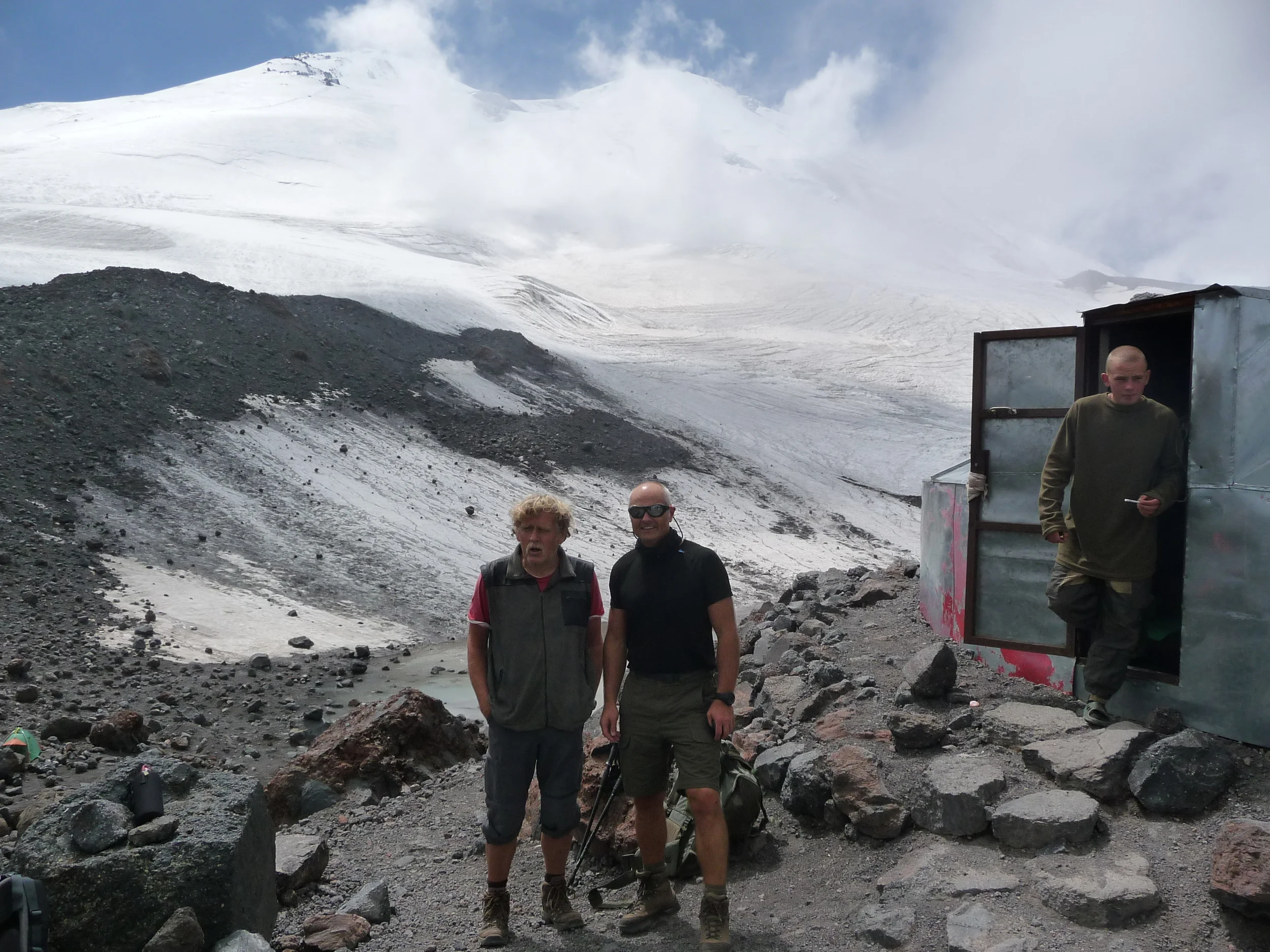 the twin peaks of elbrus east and west in the background, my tent buddy brian who snored and horse and carted more than most tent buddy's, and on the right a young russian soldier, i had discussed shaving with, even though he wouldn't be experiencing this phenomena for some time to come!