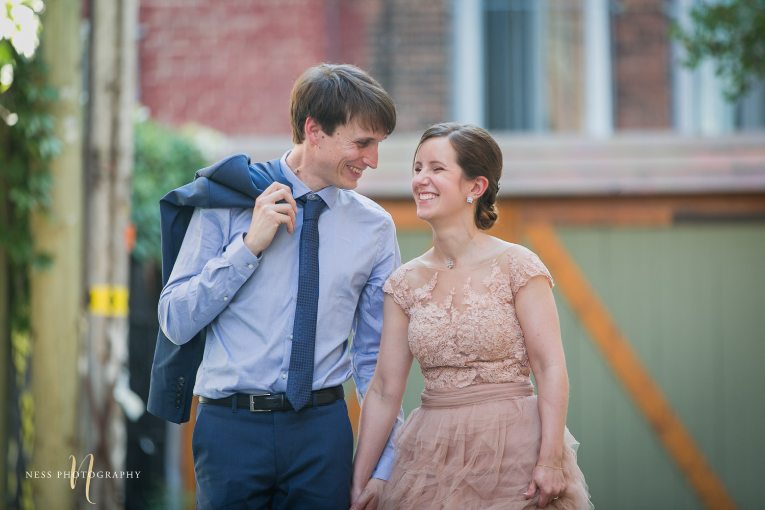 bride and groom walking and laughing during elopement wedding photos in plateau mont royal