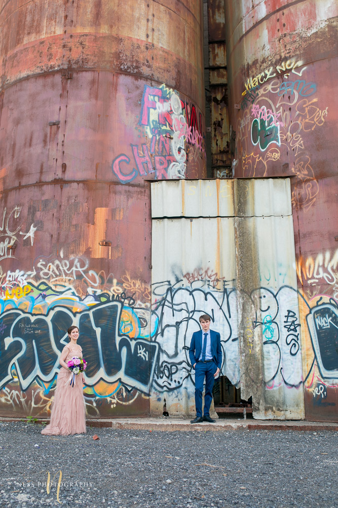 bride and groom in front of graffiti wall in canal lachine for their montreal elopement 