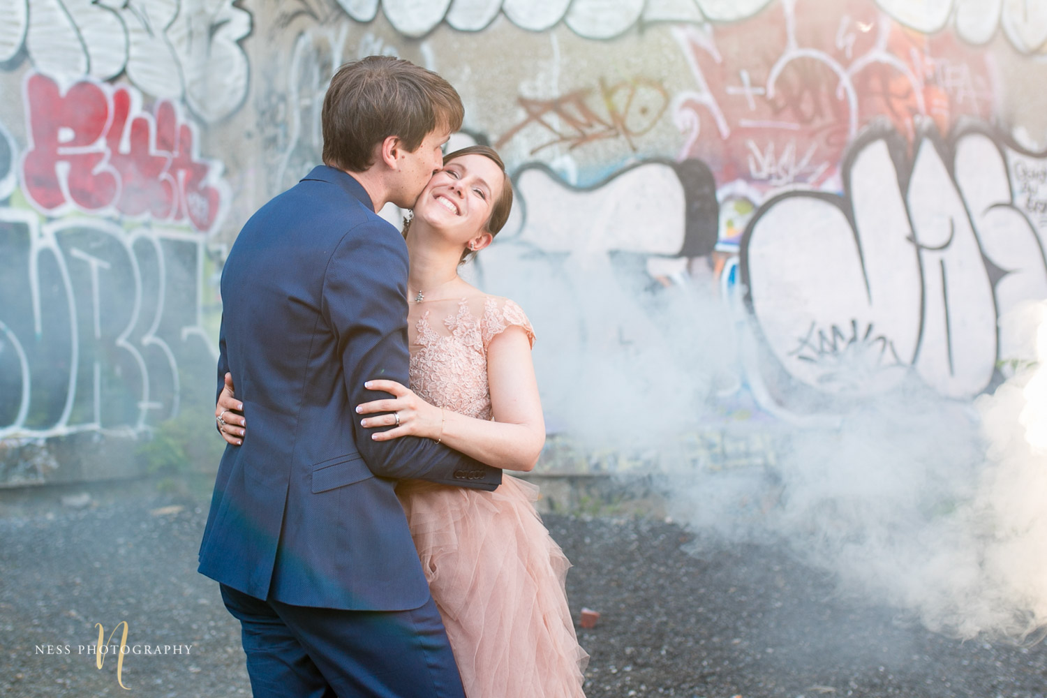 bride and groom in the middle of white smoke bomb in canal lachine for their montreal elopement 
