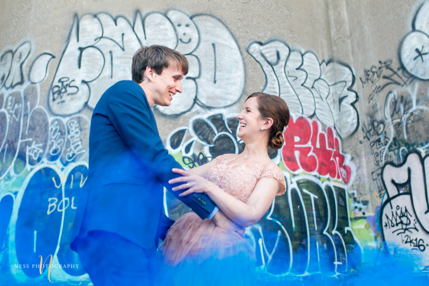 bride and groom dancing in bleu smoke bomb in canal lachine for their montreal elopement 
