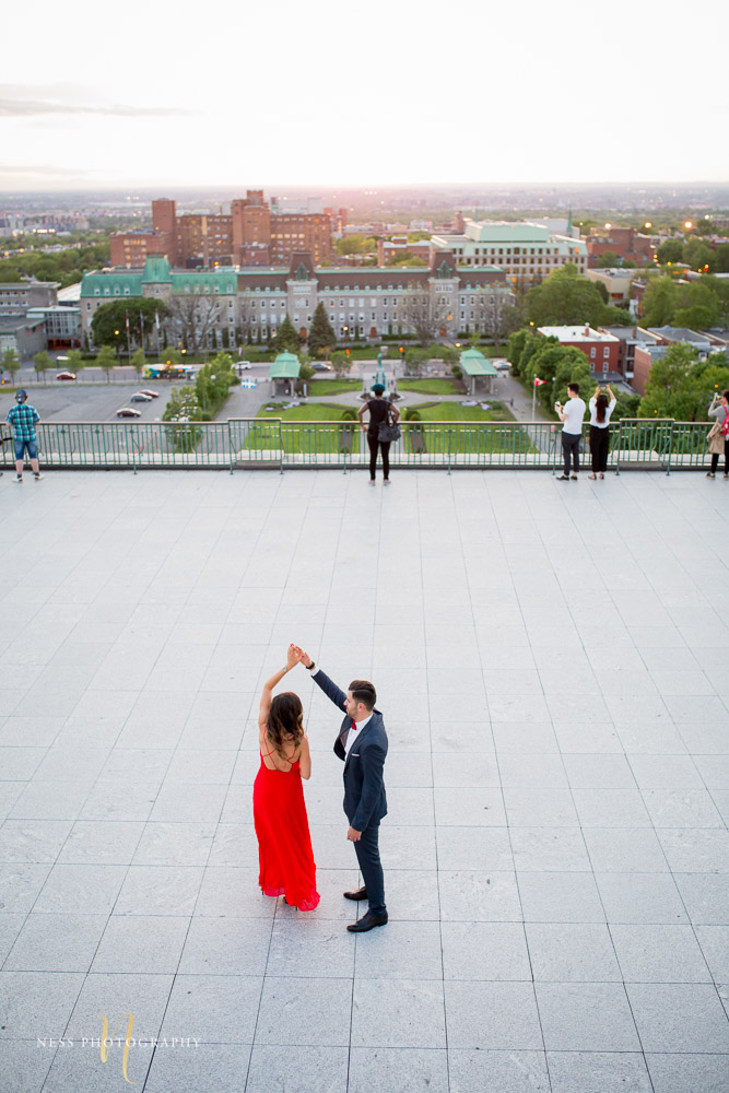 couple dancing with montreal sunset view during engagement session at saint joseph oratory