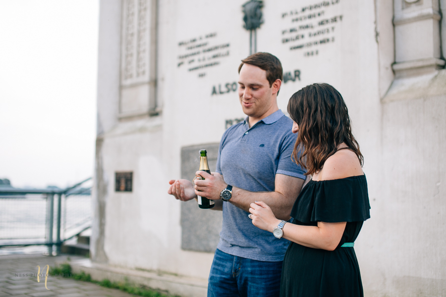 Surprise proposal  with champagne in montreal old port clock tower by ness photography montreal wedding photographer .jpg