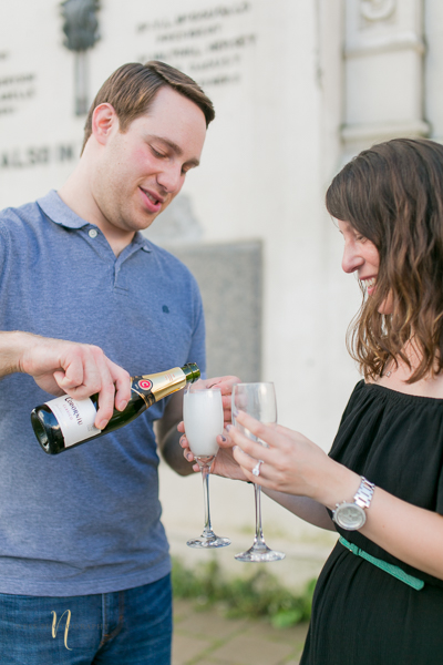 couple drinking champagne after surprise proposal in old montreal clock tower pier