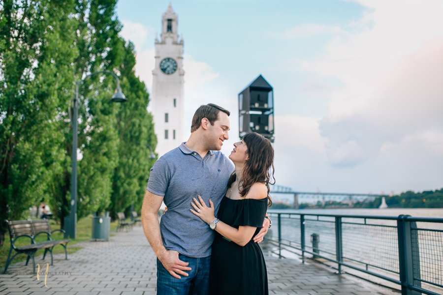 just engaged couple in montreal old port in front of clock tower