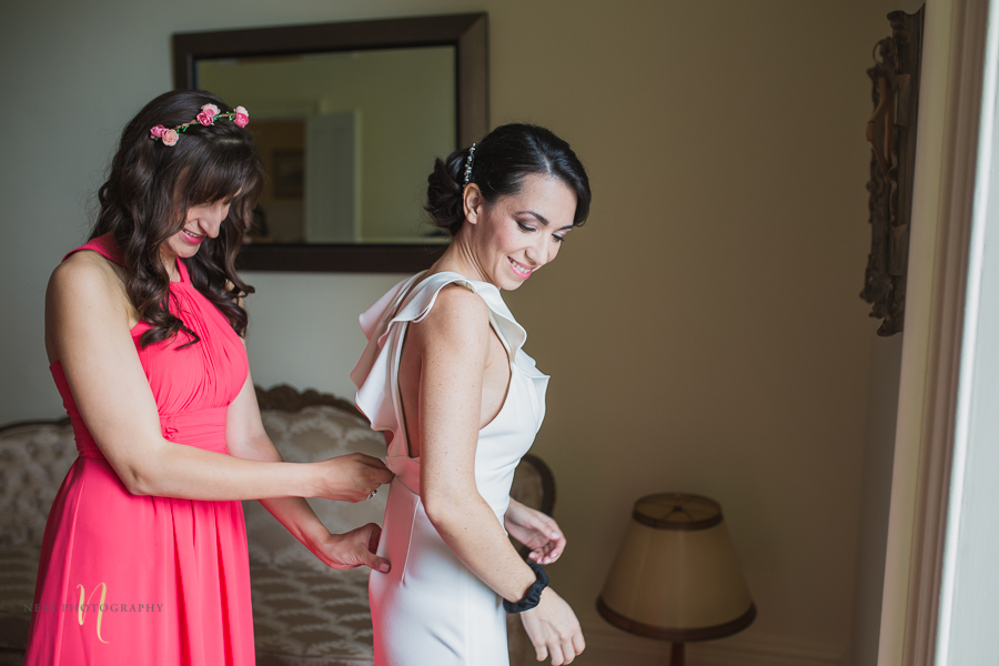 bride getting dressed at Wedding at Forest and Stream club by Ness Photography