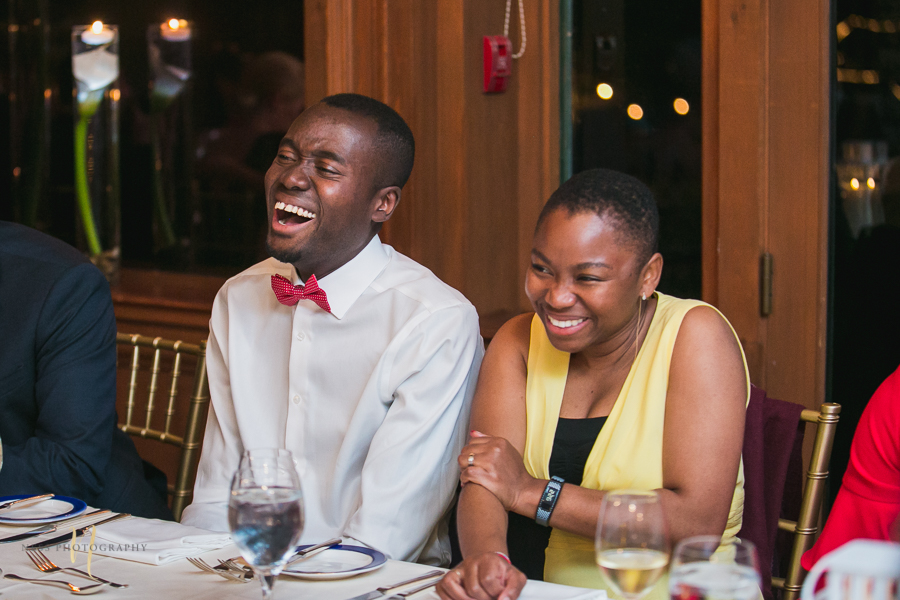 guests laughing at at Forest and Stream club wedding  by Ness Photography