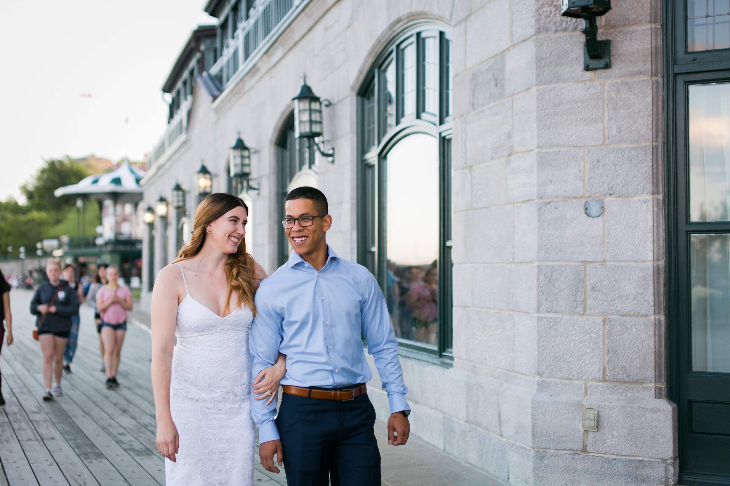 couple walking holding hands in front of chateau frontenac in old quebec