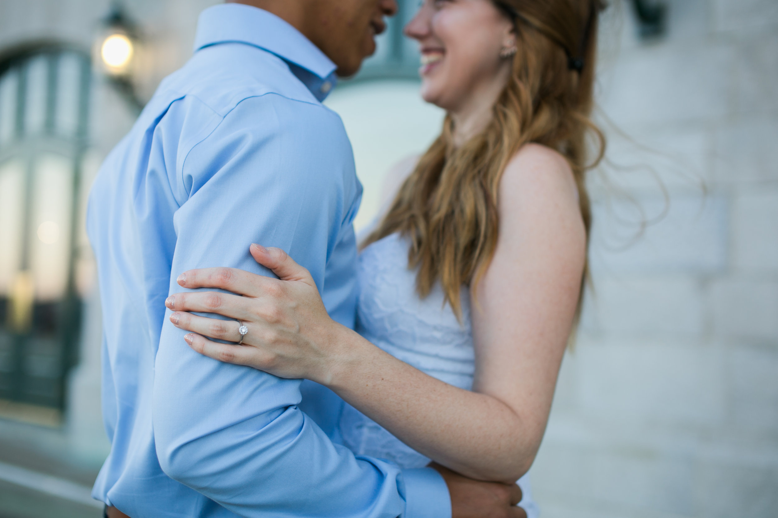 closeup of ring shot and couple smiling during engagement photos in old quebec