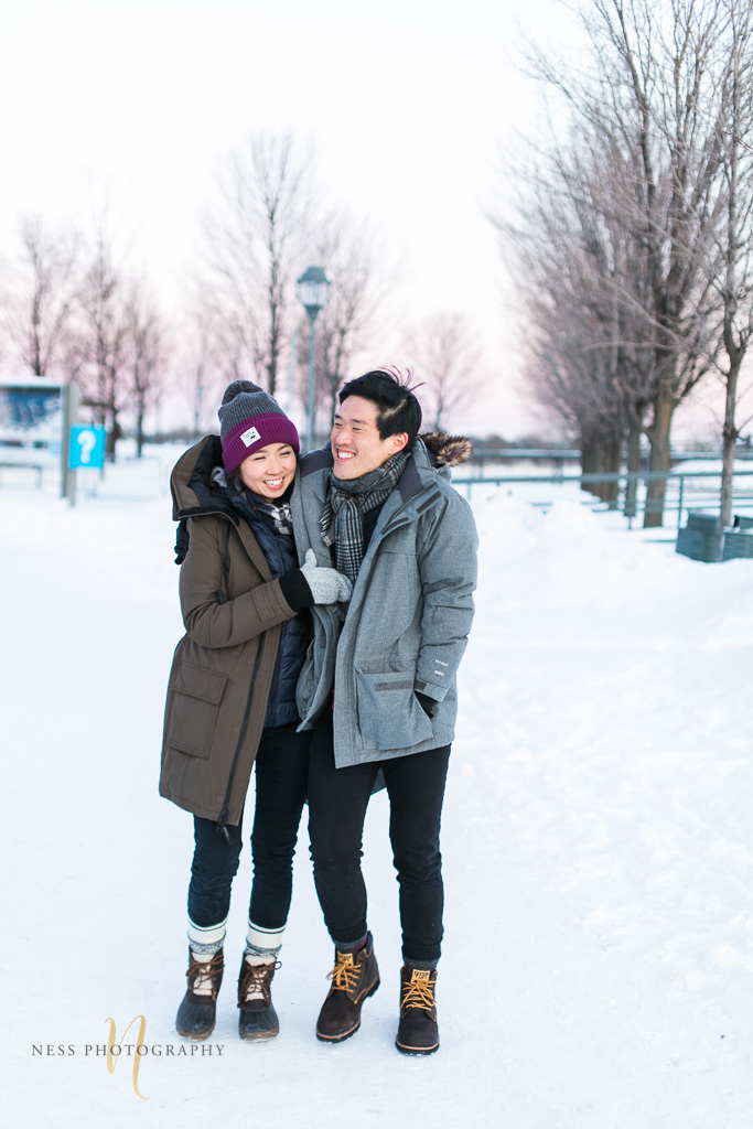 couple walking together at winter sunset engagement photoshoot in montreal old port 