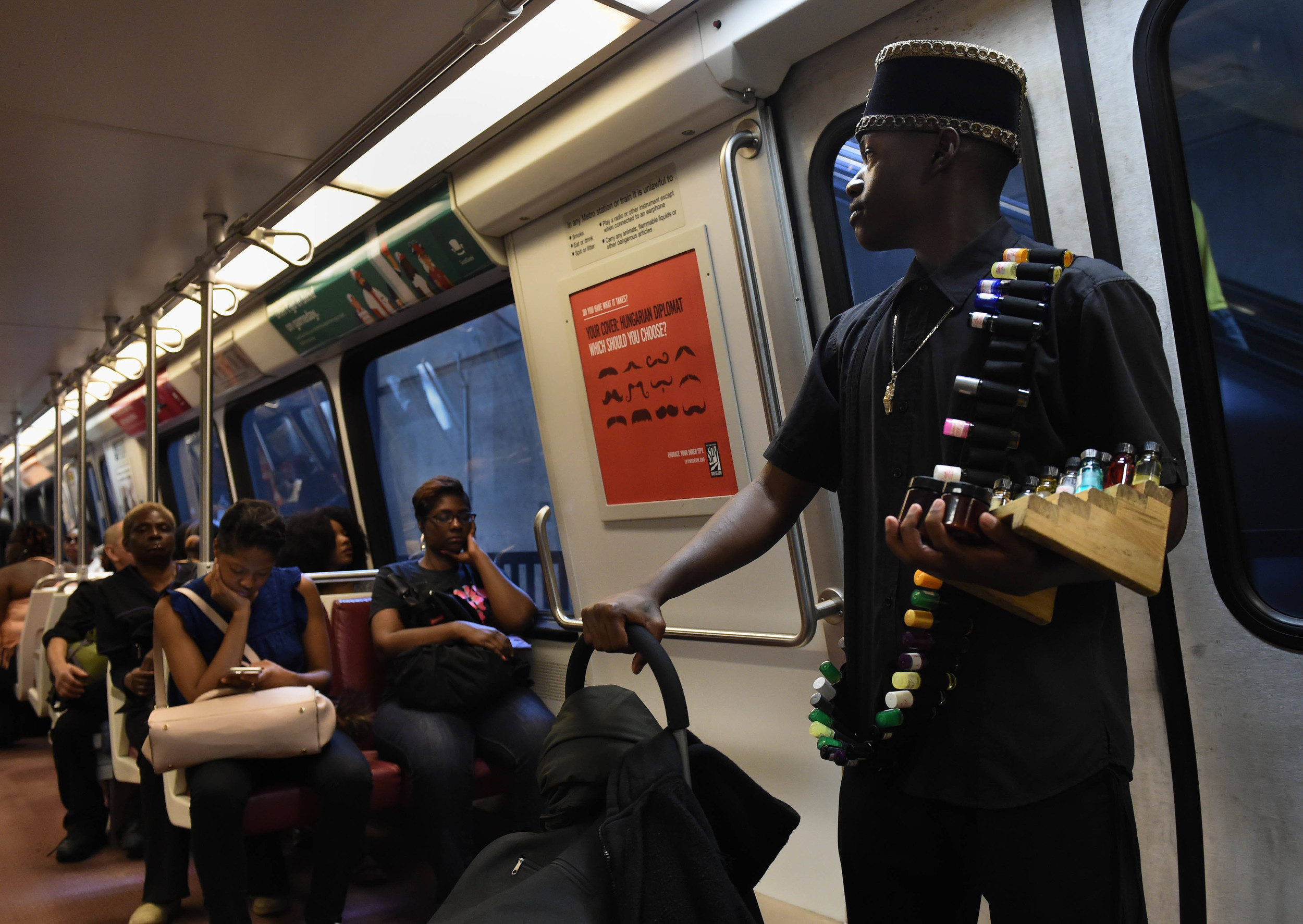  Millden Mitchell, 23, searches for potential customers while riding the subway train Saturday, June 11, 2016. He started his business after deciding he wanted out of gang life and that he wanted financial freedom. Milden sells oils and other natural fragrance products to passengers on the train. 