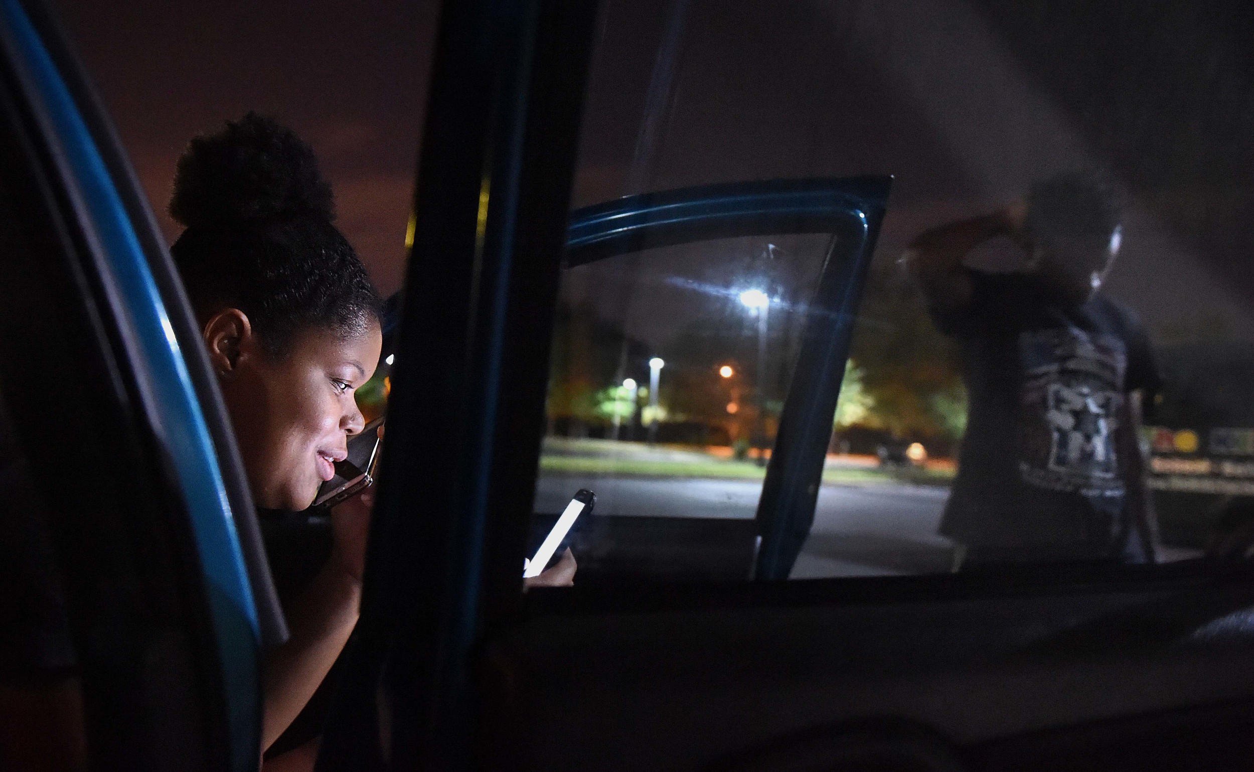  Millden stresses out while planning for the next day as Satat laughs on the phone with her father Monday, July 18, 2016.&nbsp; 