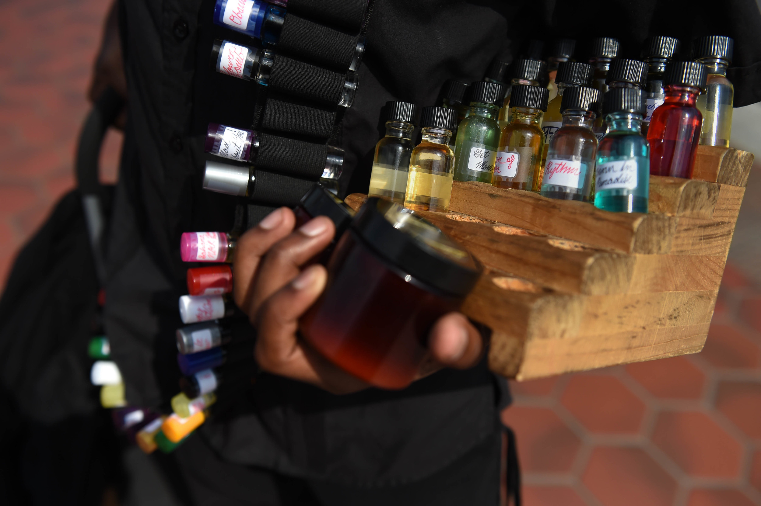  Messas holds oils that he sells to clients Saturday, June 11, 2016. 