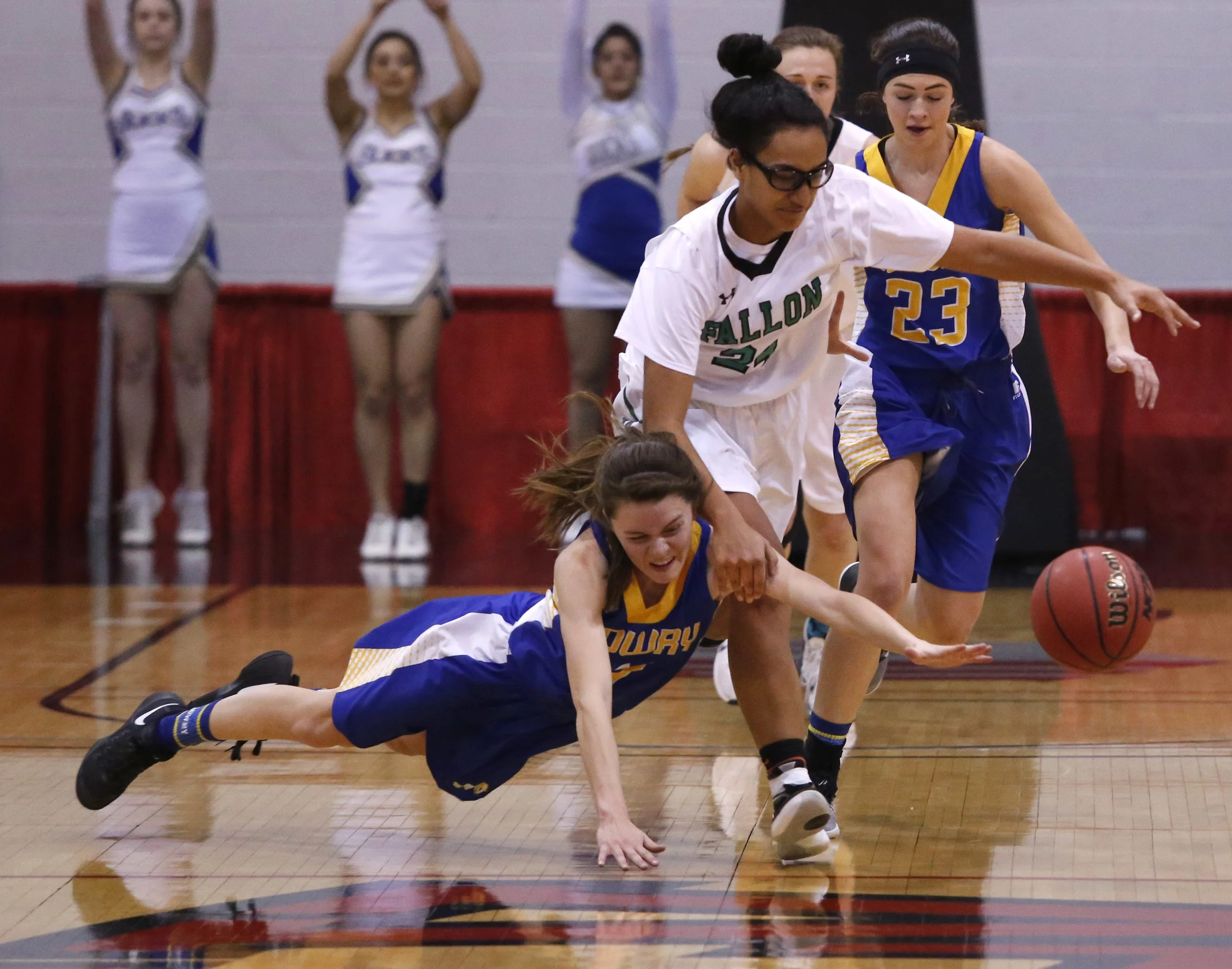  Lowry's Shelby Garrison (11) dives after a loose ball as Churchill County's Leta Otuafi (24) runs over her during the second half of a Class 3A girls state final championship game at the Cox Pavillion on Saturday, Feb. 25, 2017, in Las Vegas. Church