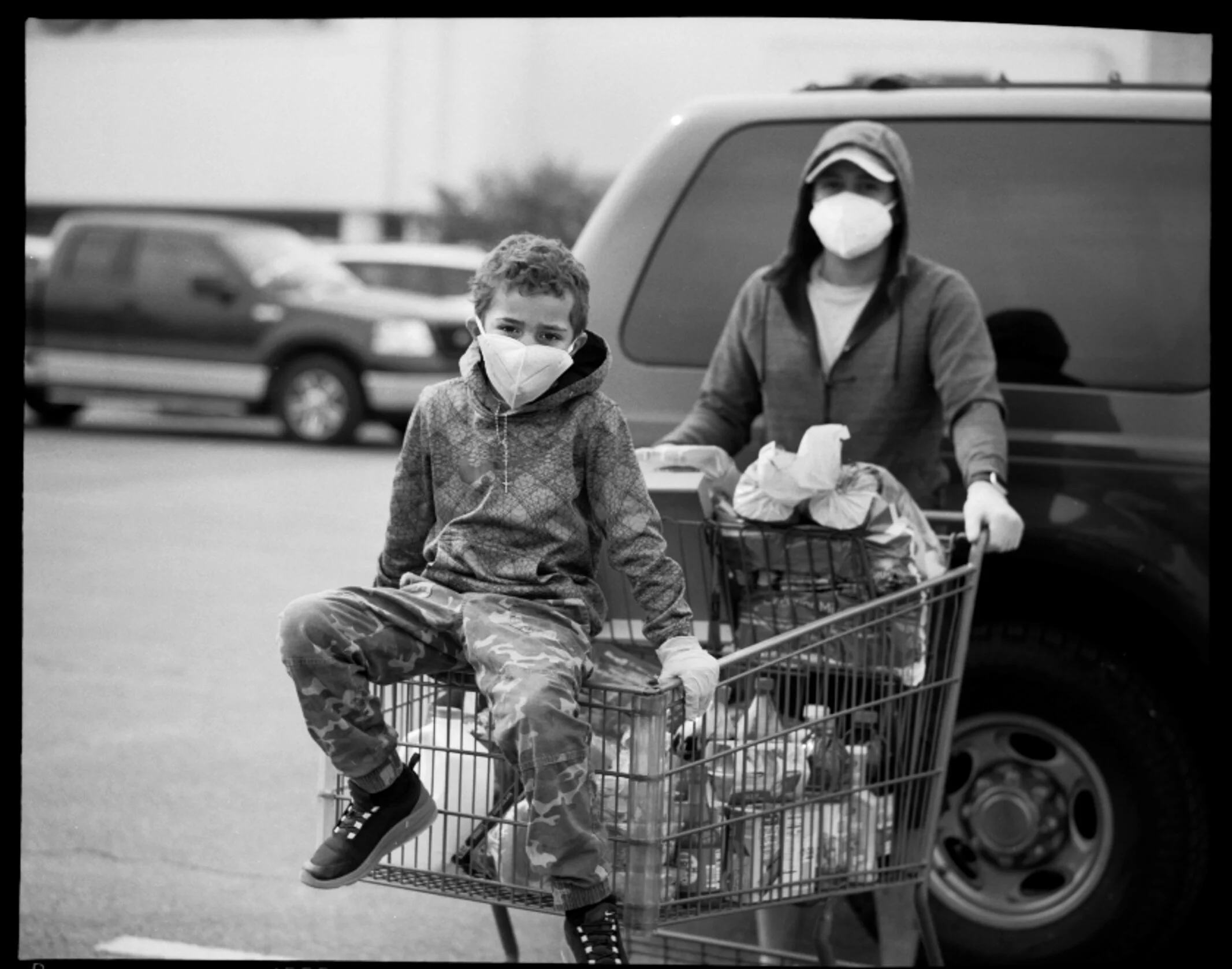  Xavier Byrd, 7, foreground, and his father Whitney Byrd, 32, wears protective masks and gloves outside of Aldis grocery store in Killeen, Tx on Friday, April 10, 2020. “I got a phone call about my cousin who died from Corona a couple days ago at the age of 13 in Chicago. That woke me up, I decided that I was going to take every precaution to protect my family,” Whitney said. 