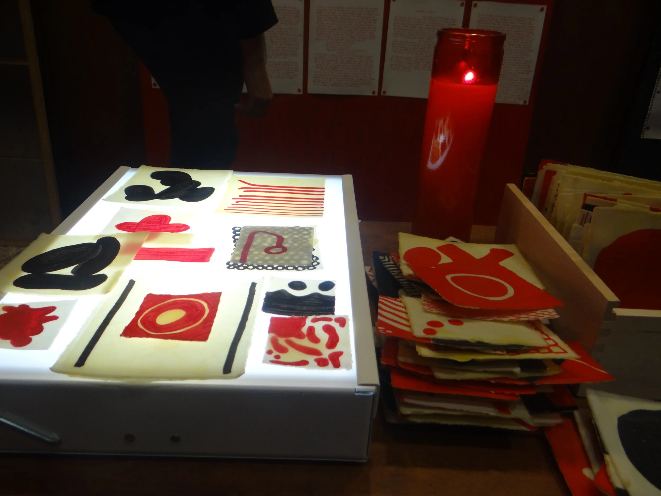beeswax-coated red and black glyphs