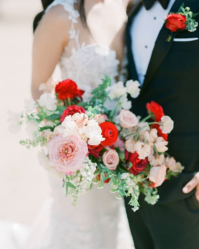 When we were working on this wedding we were planning on keeping the bridal and ceremony flowers a very soft palette. However, our bride loved color, especially red and really wanted to incorporate it throughout the entire wedding. And I am so glad s