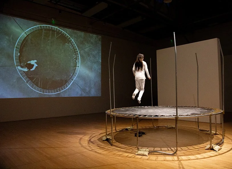 A trampoline becomes the platform for a living drawing, where a large chalk piece is layered over original architectural renderings from Xie's grandfather—blueprints from the 1960s.
