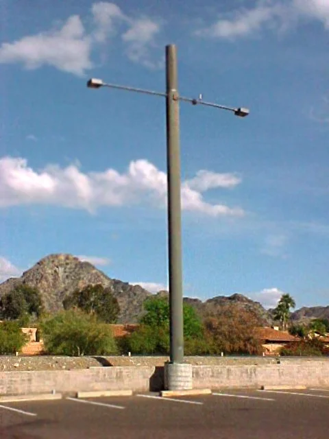 New light pole installations in a commercial parking lot. 