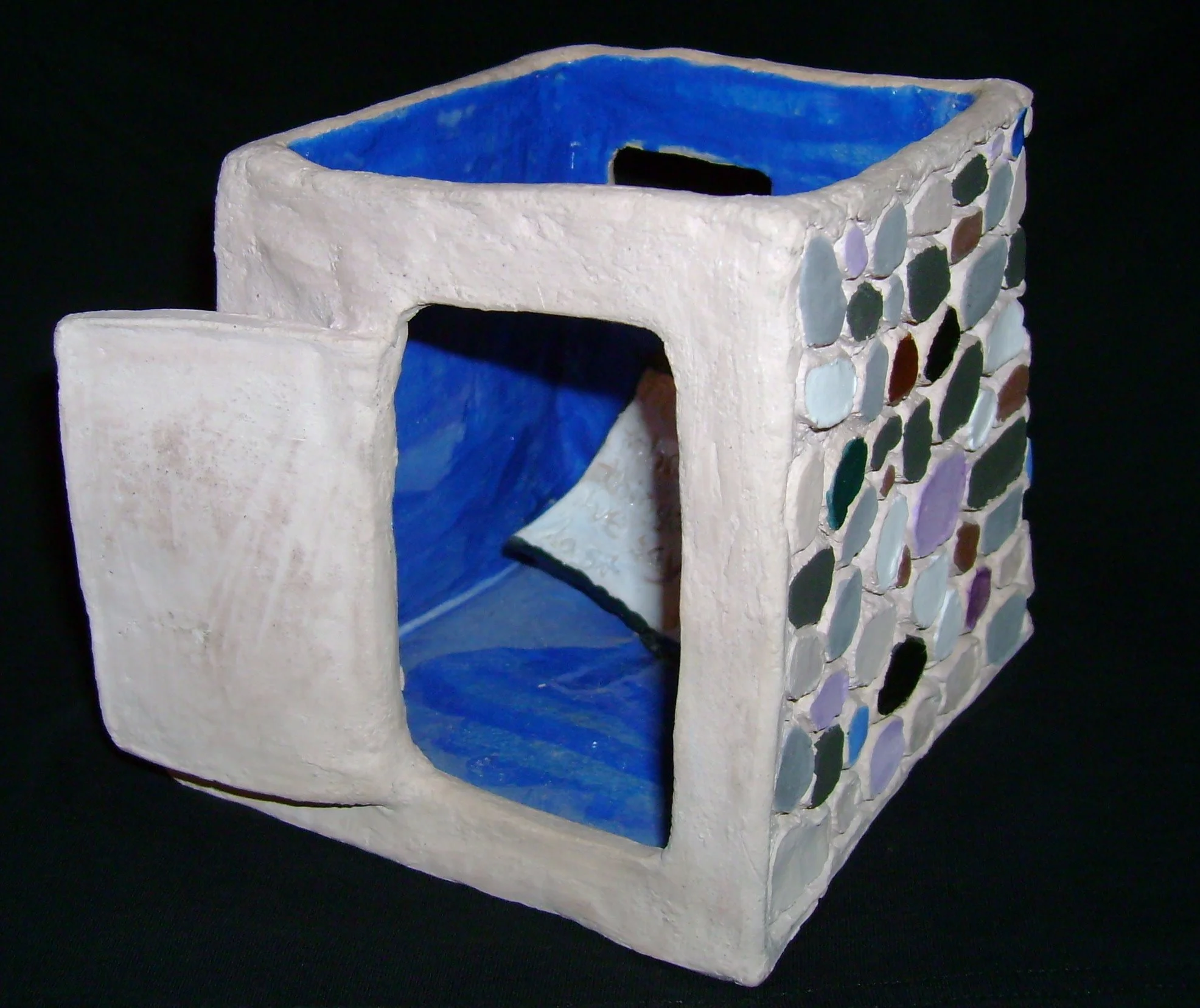 "the things we say last."  2004.  Stoneware, hand-built home form with codex motif.