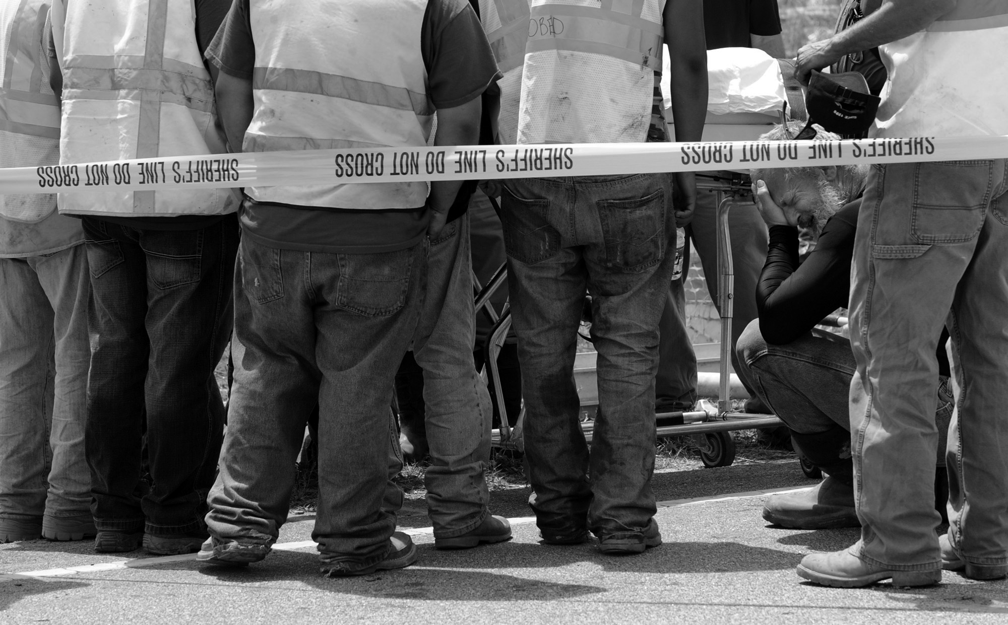 Construction workers gather to pray around the body of one of their coworkers after local fire departments extracated his body from a construction accident on Scuffletown Road in Fountain Inn. (June 14, 2012)