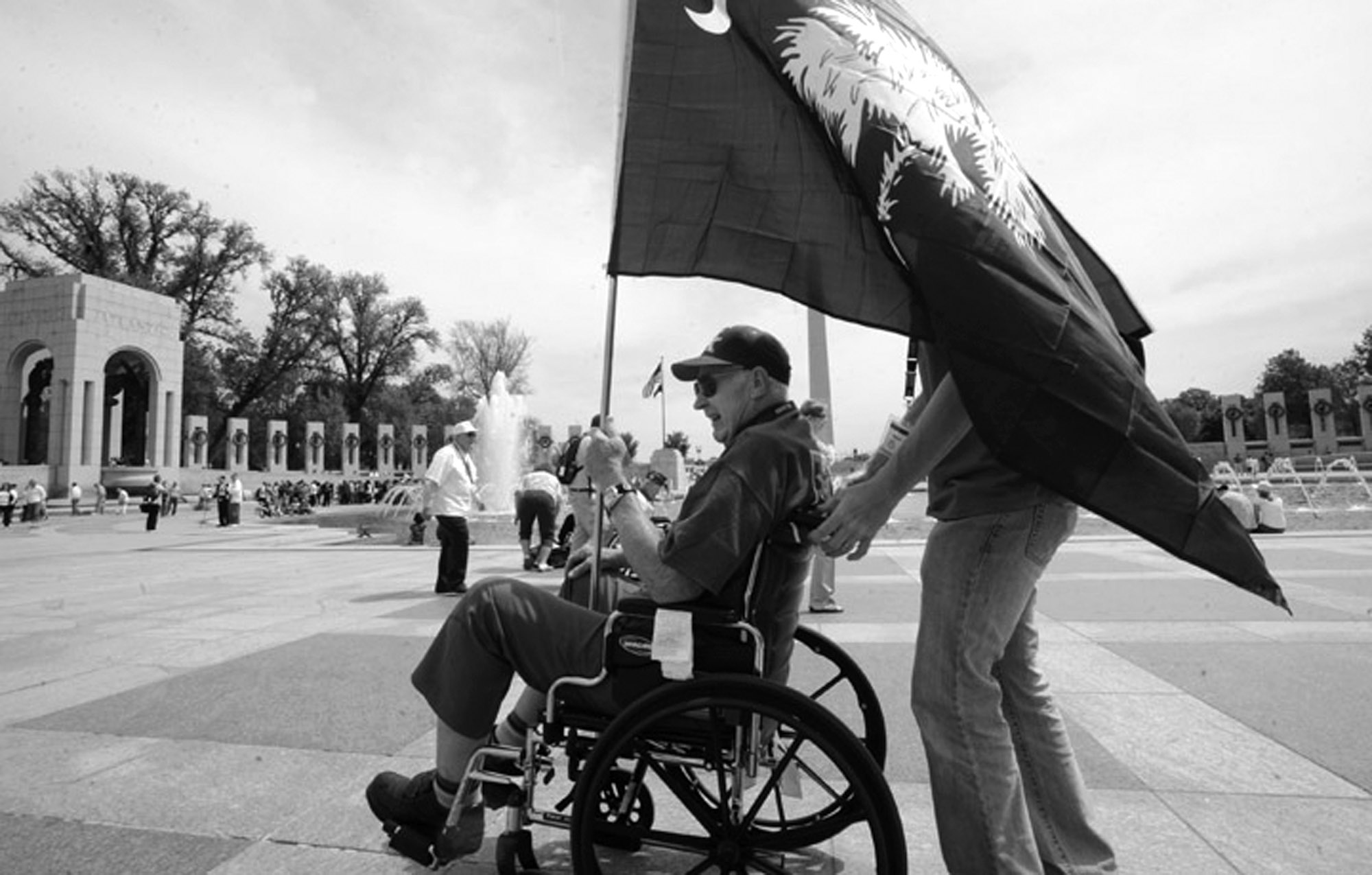  A veteran carries a South Carolina state flag through the World War II Memorial in Washington, D.C. He was part of a group of South Carolina World War II veterans to travel to Washington as part of Honor Flight Upstate. 