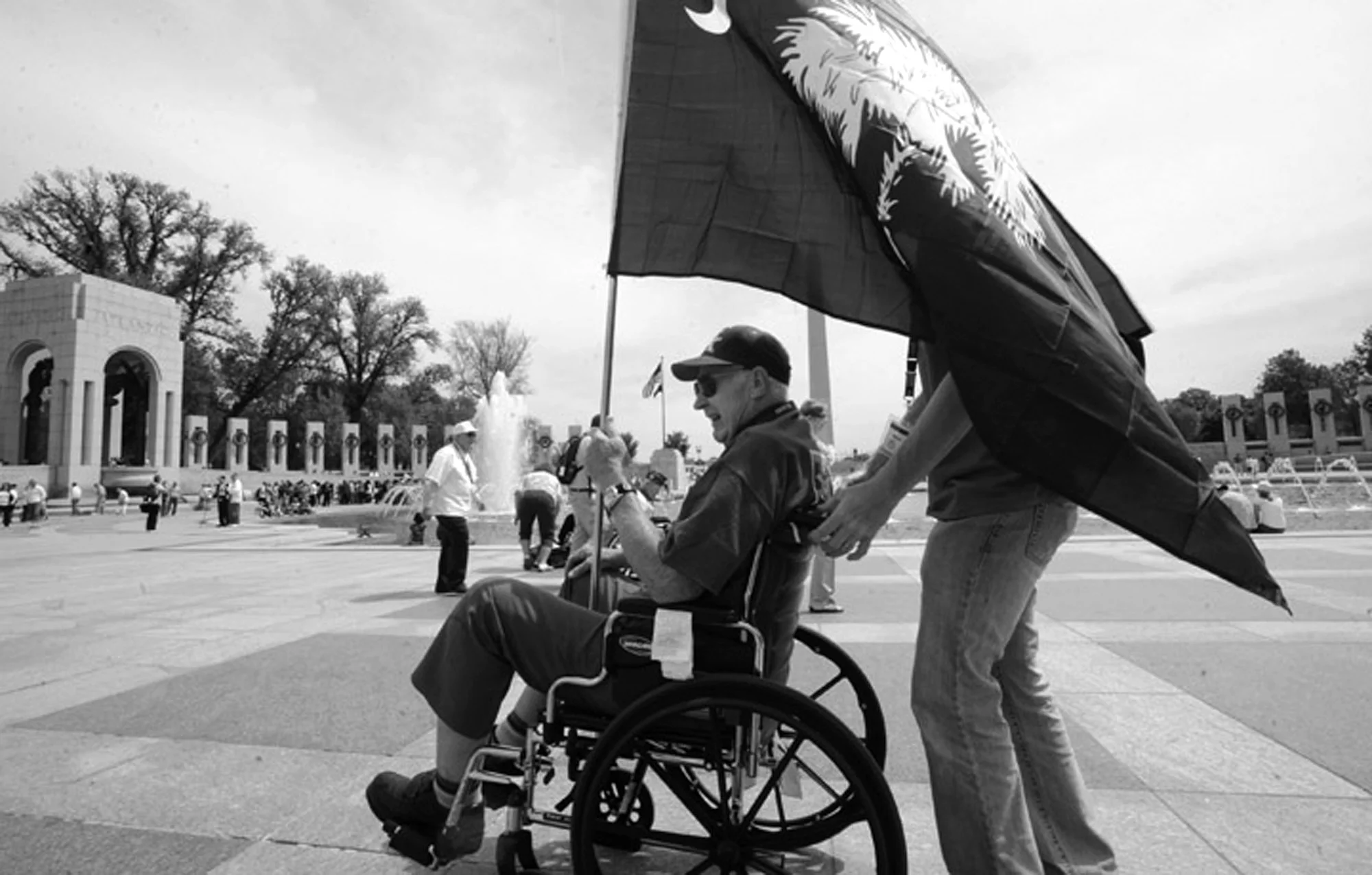 A veteran carries a South Carolina state flag through the World War II Memorial in Washington, D.C. He was part of a group of South Carolina World War II veterans to travel to Washington as part of Honor Flight Upstate.