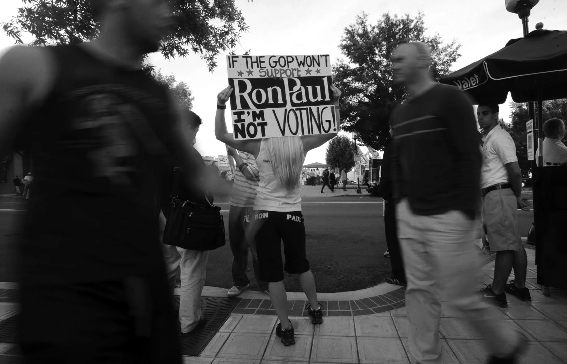 A Ron Paul supporter waves a sign for people walking along Main Street in Greenville, S.C., before the start of the South Carolina republican presidential debate.