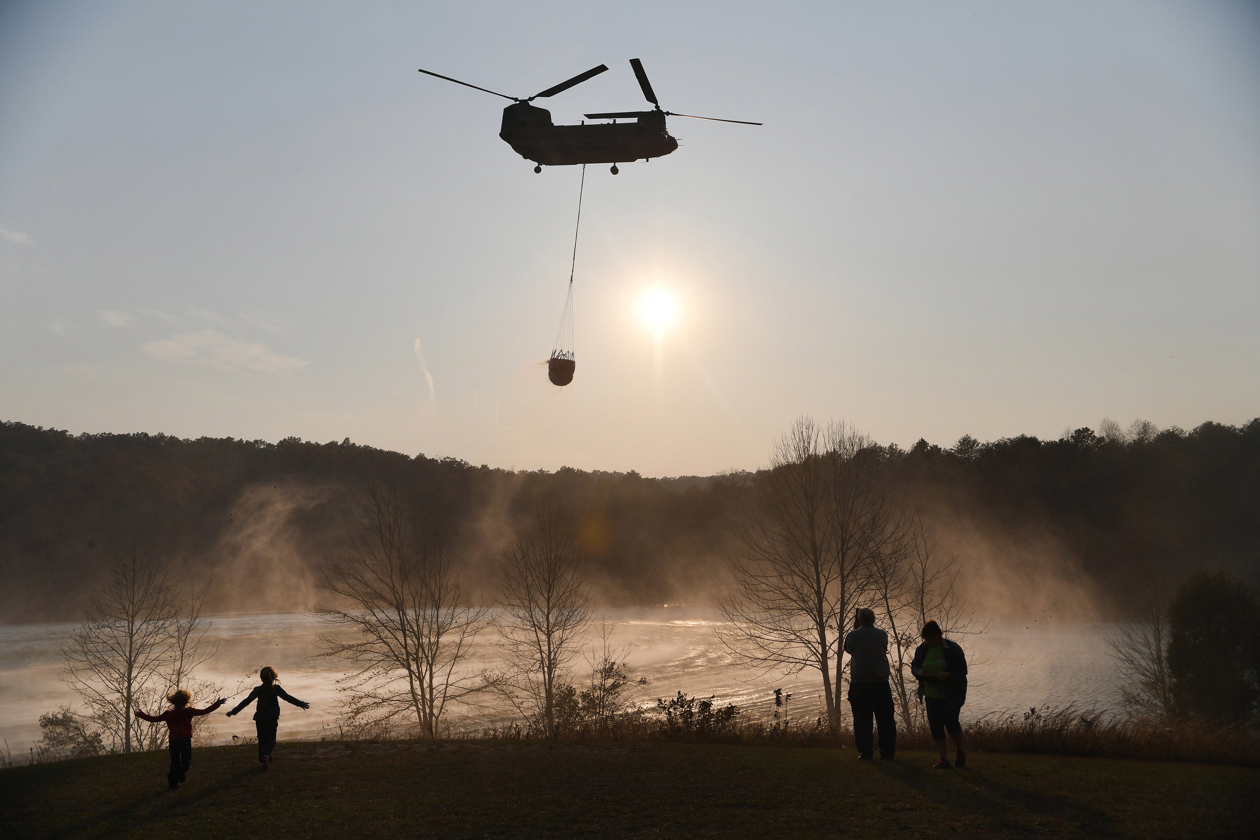  A Chinook pulls water out of Lake Oolenoy near Table Rock State Park on Tuesday, November 15, as firefighters continue to battle wildfires. 