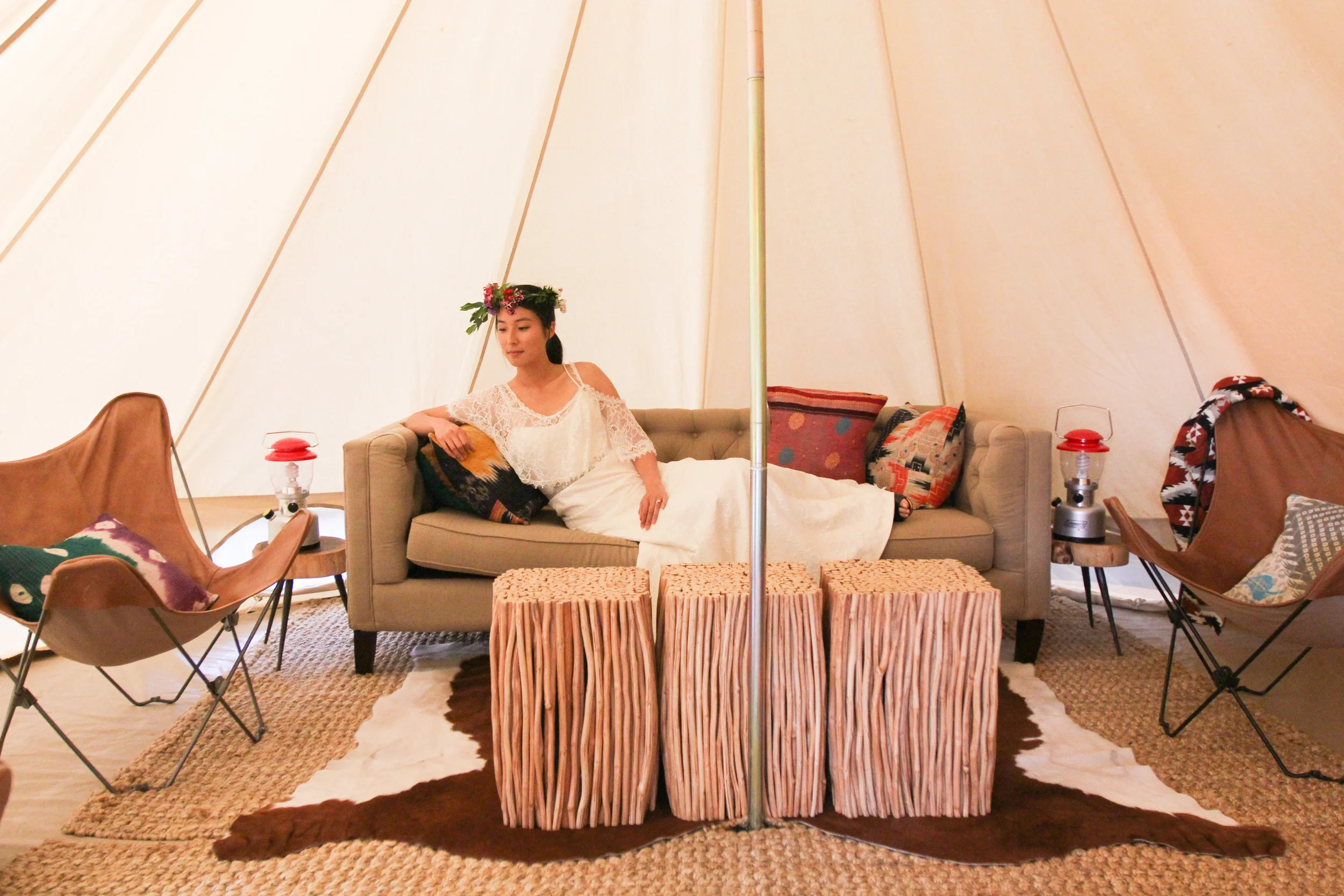 Lounge in the Joni wedding dress in a luxury tent by Shelter Co . 