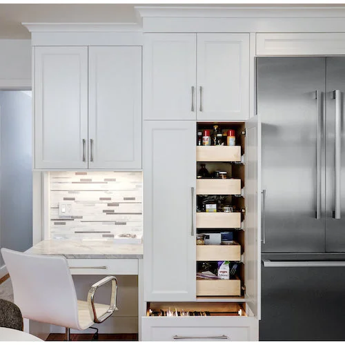A transitional kitchen featuring a pull-out pantry and file drawer next to a built-in desk.