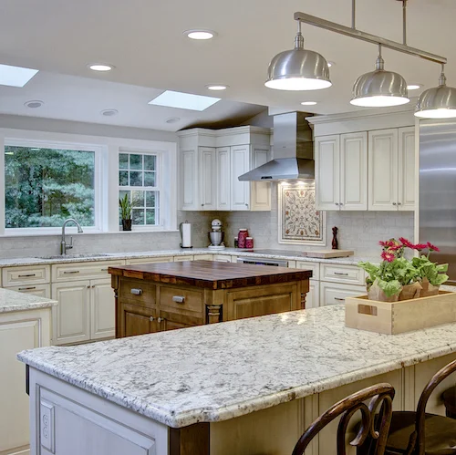 A large kitchen in Sudbury supports two separate islands with storage, eating areas, and plenty of space for food prep and serving.