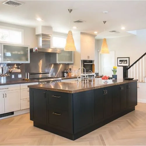 A Rhode Island kitchen features a contrasting painted island with a concrete surface and storage on all four sides with built-in freezer drawers on the end of the island.
