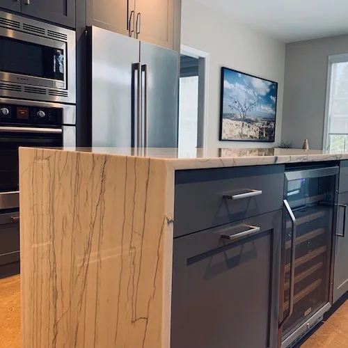Wayland kitchen with a modern waterfall edge on the island.
