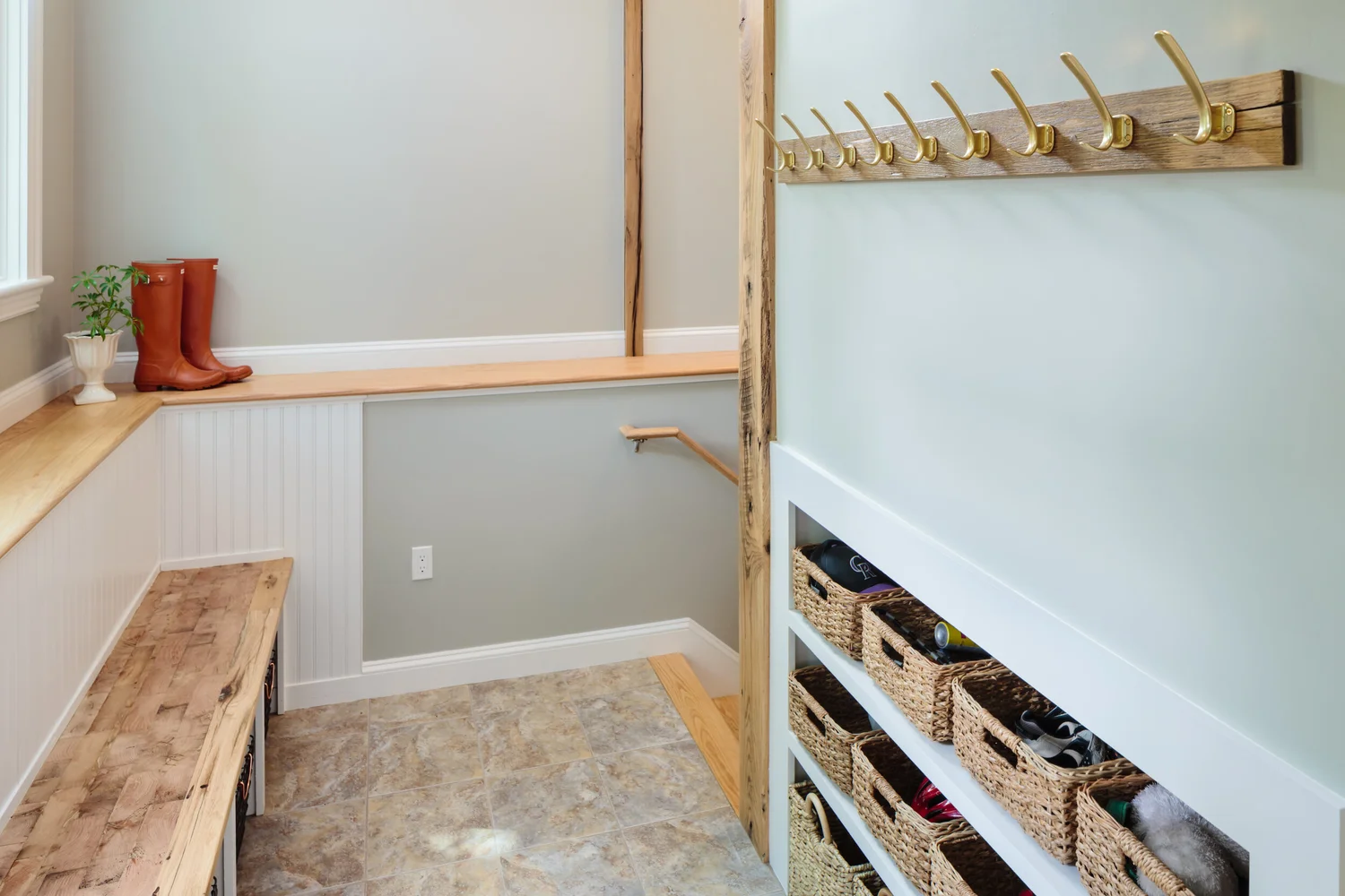 Belmont mudroom with wood elements warms up the space. The bench is end-grain inlaid in edge grain. Photo by: Michael Lefebvre