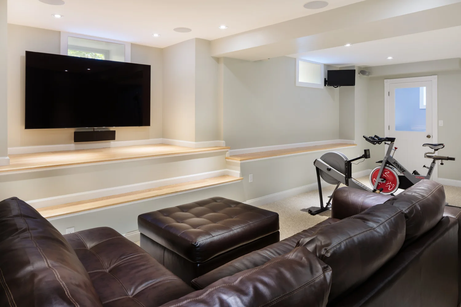 Belmont basement offers space for relaxation and working out. Builder: Jensenhus Photographer: Michael Lefebvre