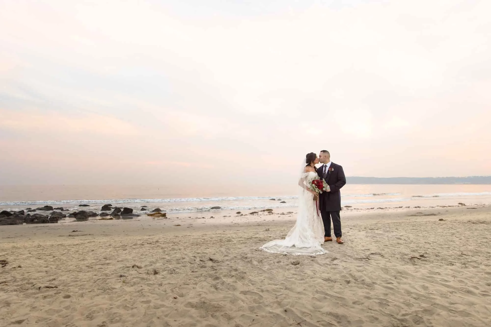Bride and groom standing on the beach at sunset in San Diego CA (Copy)