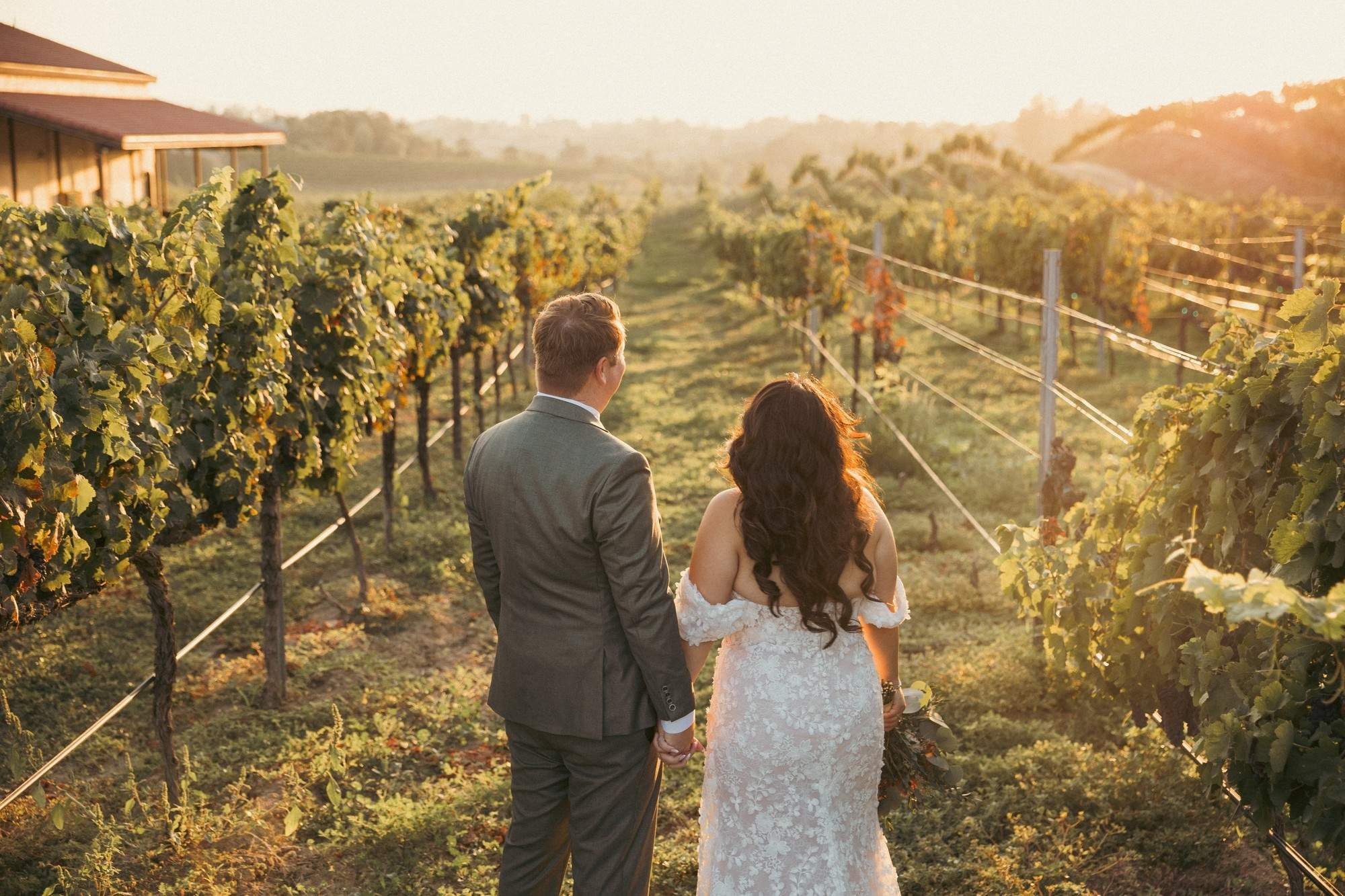Newlyweds walking through a vineyard at golden hour in Temecula CA (Copy)