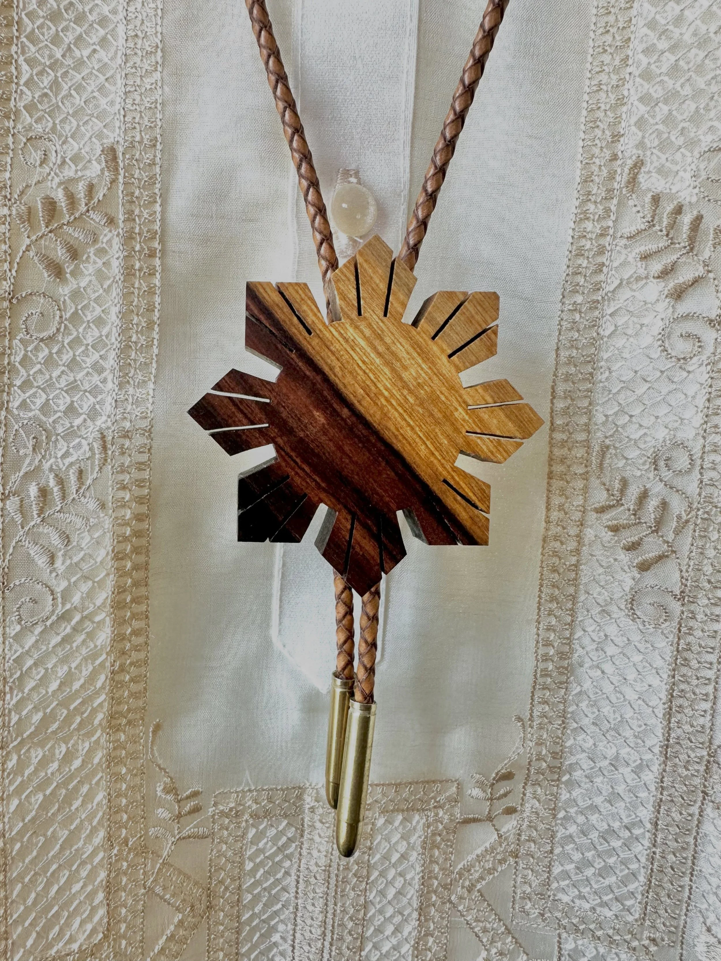3&rdquo; Araw Bolo in Bolivian Rosewood with brown leather braided cord and brass bullet tips. Fun fact: this species of wood is what&rsquo;s known as a &ldquo;sensitizer,&rdquo; and you can develop a contact allergy to it, as I found out around midd