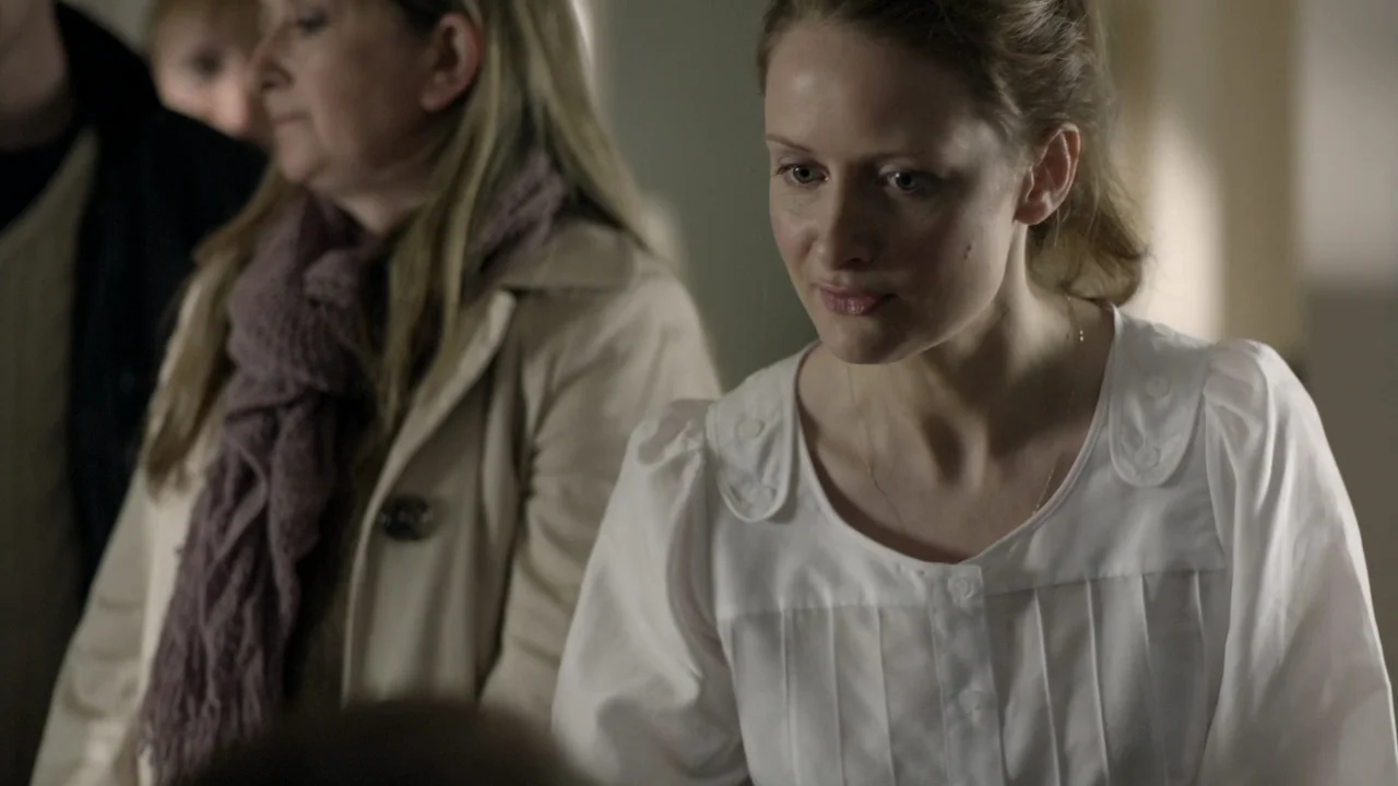 Very feminine blouse, three buttons covering the shoulder, puff sleeves, pleats down the front, and with a peasant influence.