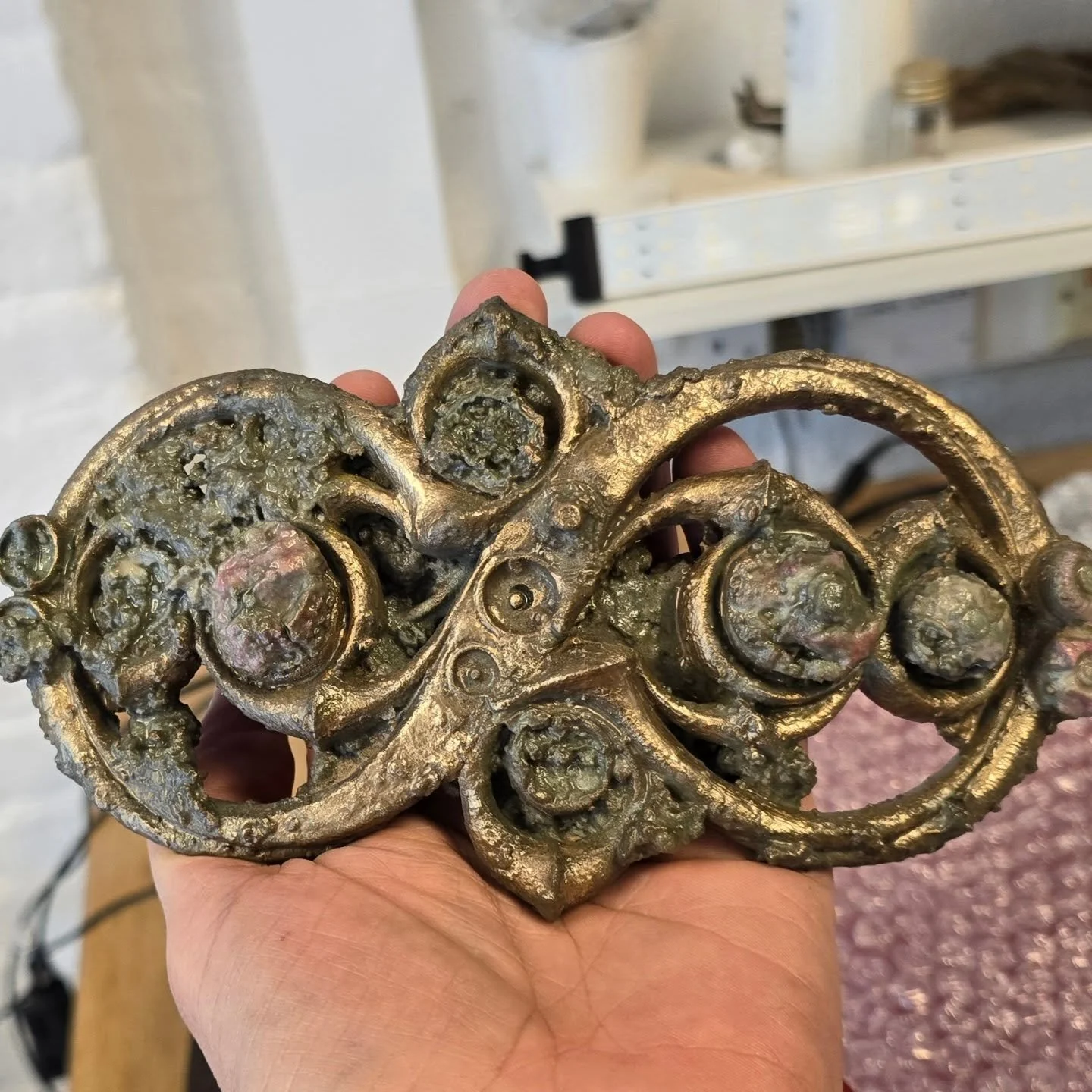 Earlier this year, we made this replica iron age strap junction, part of the newly discovered Melsonby hoard, for York Museum Trust. This simulates how it looked out of the ground, including simulated mud. The bronze and coral decorations are enhance