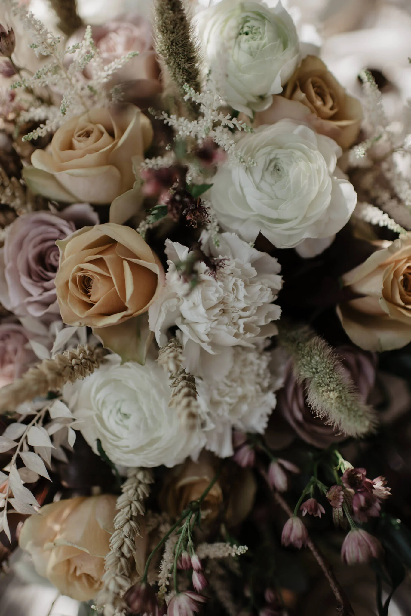 Bridal bouquet with soft muted tones of lilac and orange