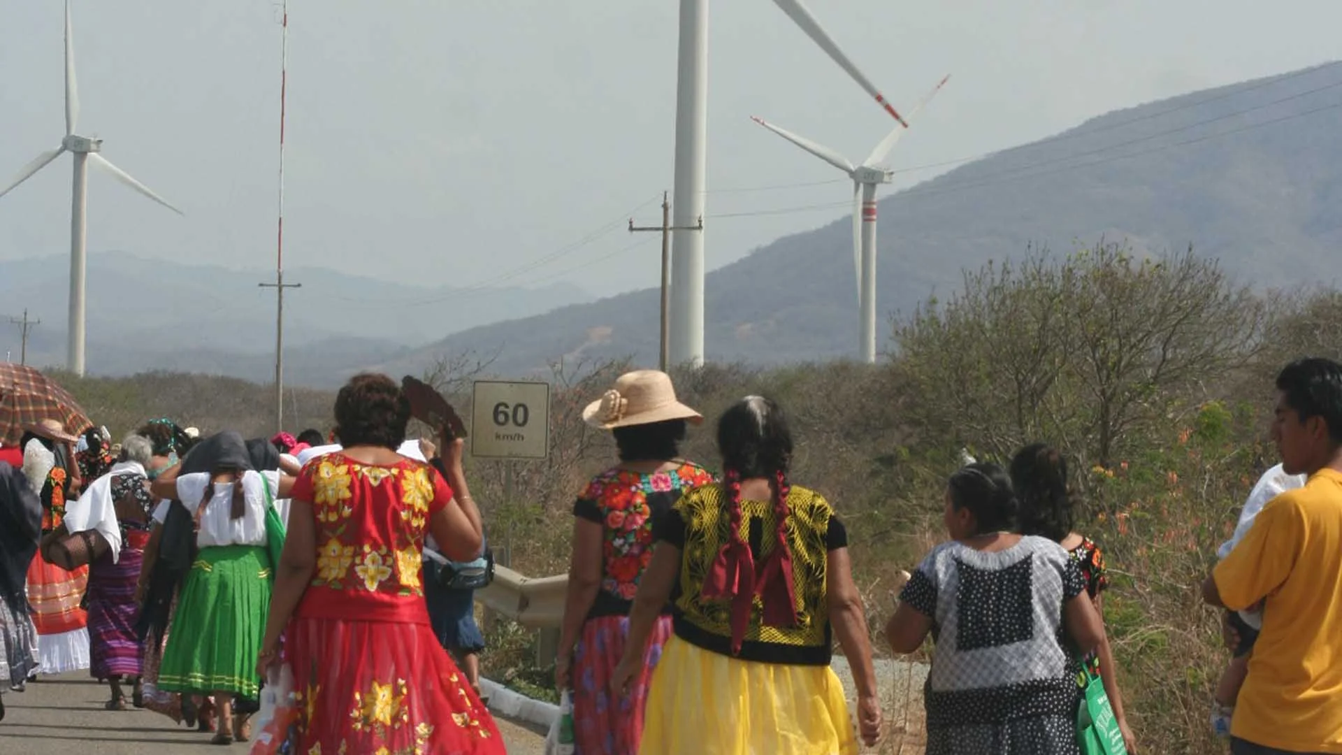 Indigenous communities walk past a large wind farm in Oaxaca, Mexico