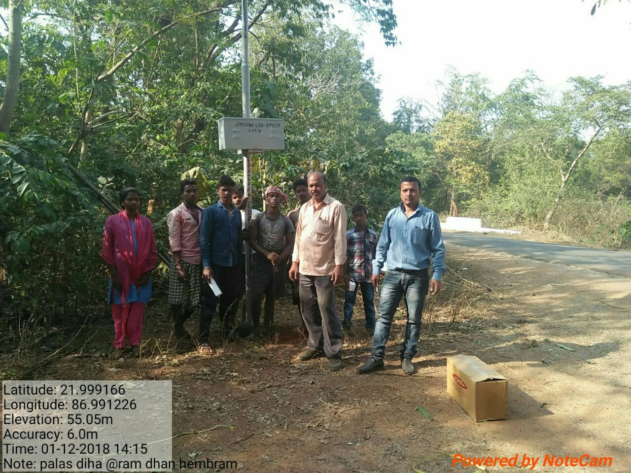 Bindu Kumar of Urjaa Samadhan, 3rd from right (cream shirt), with residents of a village in Mayurbhanj. A streetlight battery shown just above head-height.