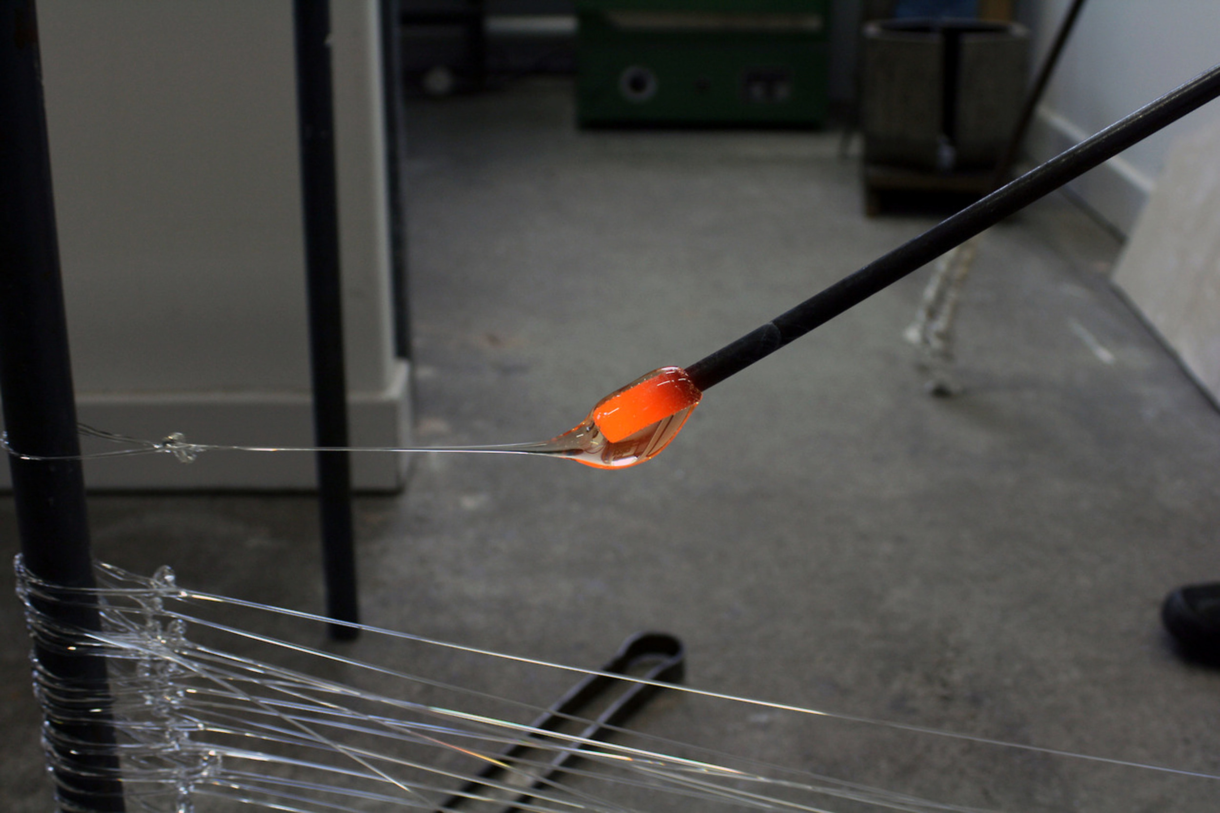 The use of glass draws inspiration from the ancient Venetian glassblowing technique, ‘murrini'. Each of the glass threads used in the work is individually pulled by hand from a furnace. 