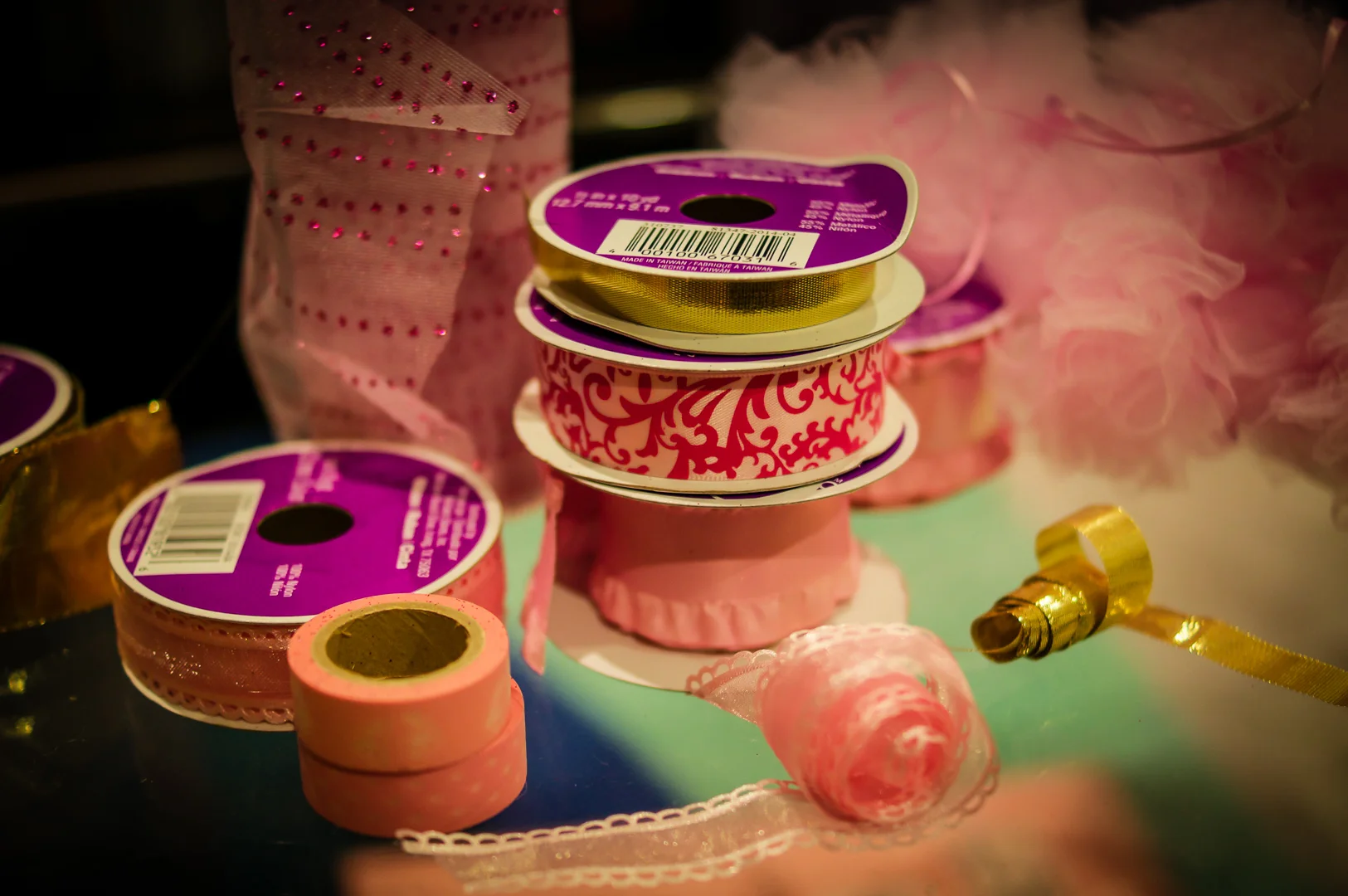 Ribbons (Patterned satin pink damask , translucent or sheer, opaque, golden) You should have at least three types of ribbons ready for your cake, in different opacities, widths and patterns. Mesh Tulle (pink and glittery) Decorations (fluffy pink lace balls)